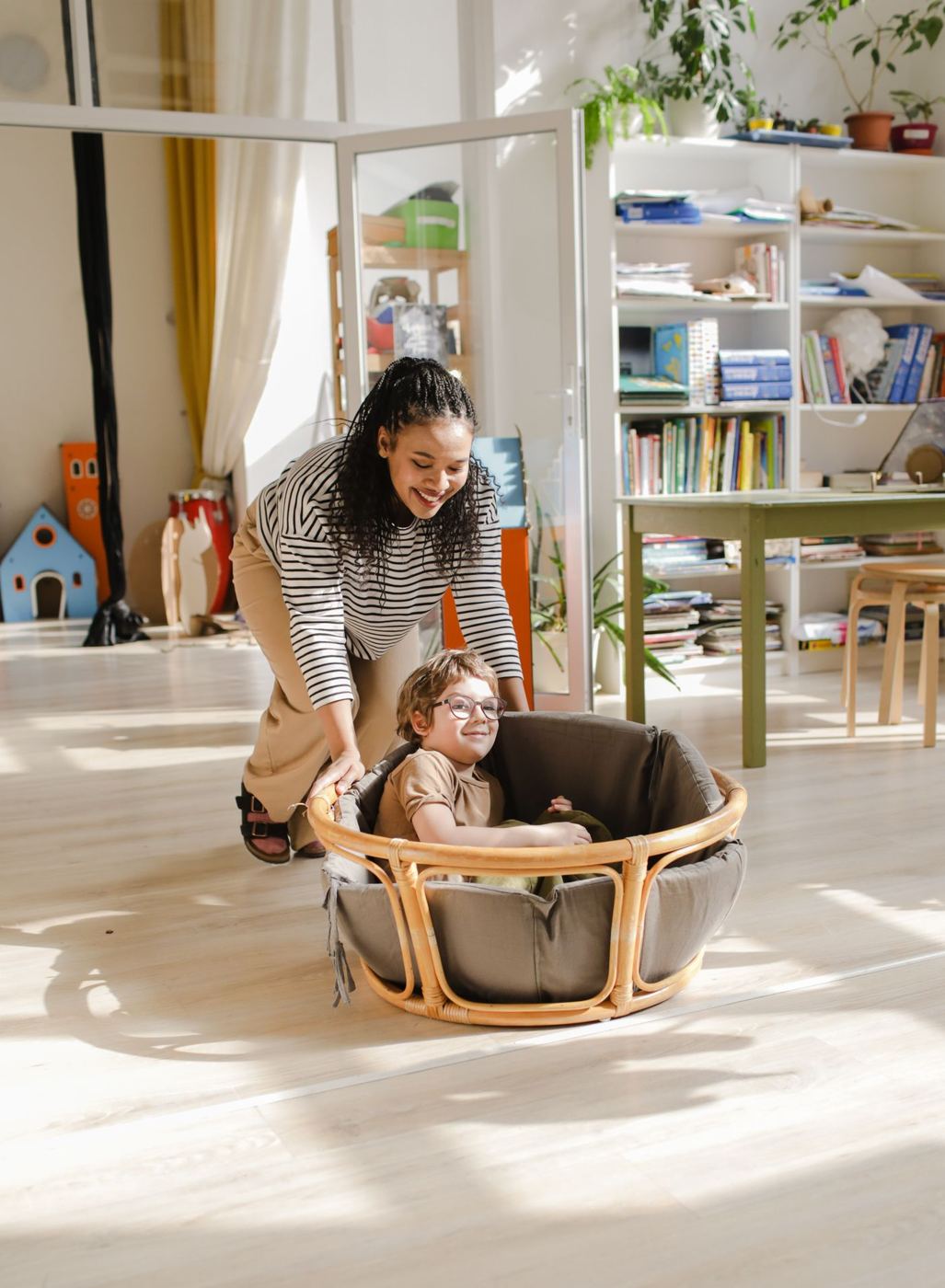 A teacher playing with a child during a session